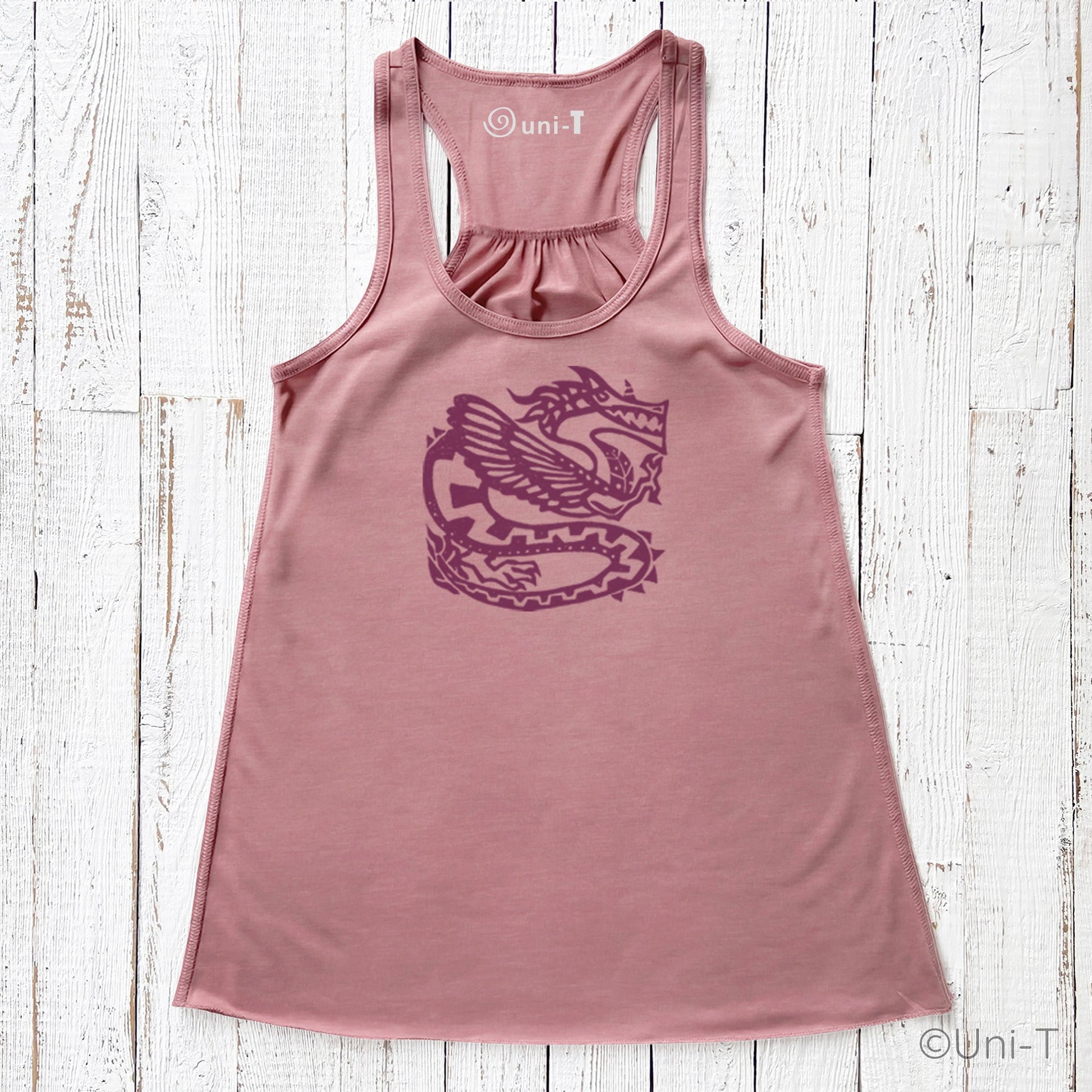 Dusty rose women's tank top with a purple dragon design, blending mythical elegance and sustainable apparel style.