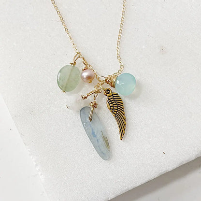 Dainty Gold Filled Necklace with gemstone charms including kyanite, pearl, and angel wing, perfect for layering or gifting.