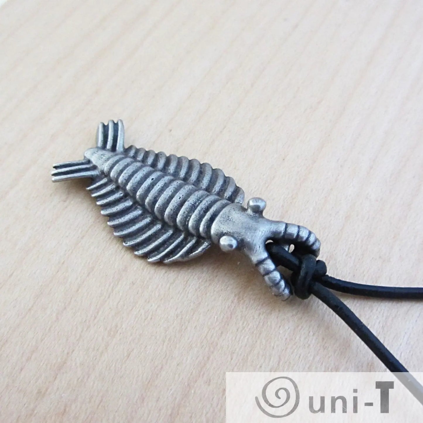 Close-up of Anomalocaris Necklace Jewelry showing detailed ridges and antennae on the silver-toned pendant, ideal for ocean-themed fashion.