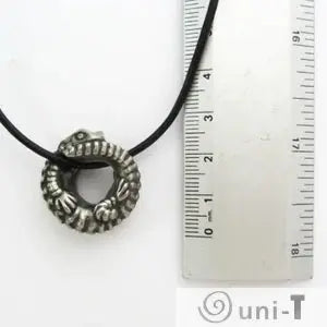 Close-up of Armadillo Lizard Necklace next to ruler for scale. Coiled lizard pendant highlights intricate desert reptile art details.