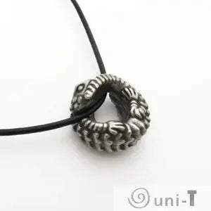 Side view of Armadillo Lizard Necklace with pendant looped through black cord. Desert reptile art piece with realistic texture.