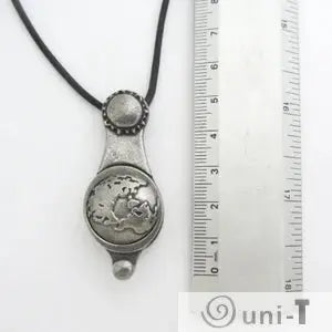 Articulating Tides Necklace next to ruler for size reference. Unique ocean-inspired jewelry showing celestial influence on tides.