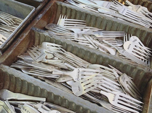 Cheddar Cheese Marker Set with assorted cheese marker fork parts organized in metal trays, ideal for labeling cheese types at events.