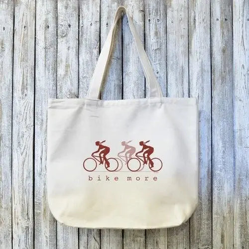 Cycling Gift Tote Bag with BIKE MORE design featuring three cyclists in red tones on organic cotton. Ideal for eco-conscious bike lovers.