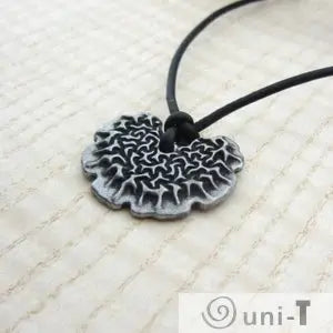 Angled view of Bacillus subtilis Necklace pendant showing textured biofilm design. Elegant Bacillus subtilis jewelry for science enthusiasts.
