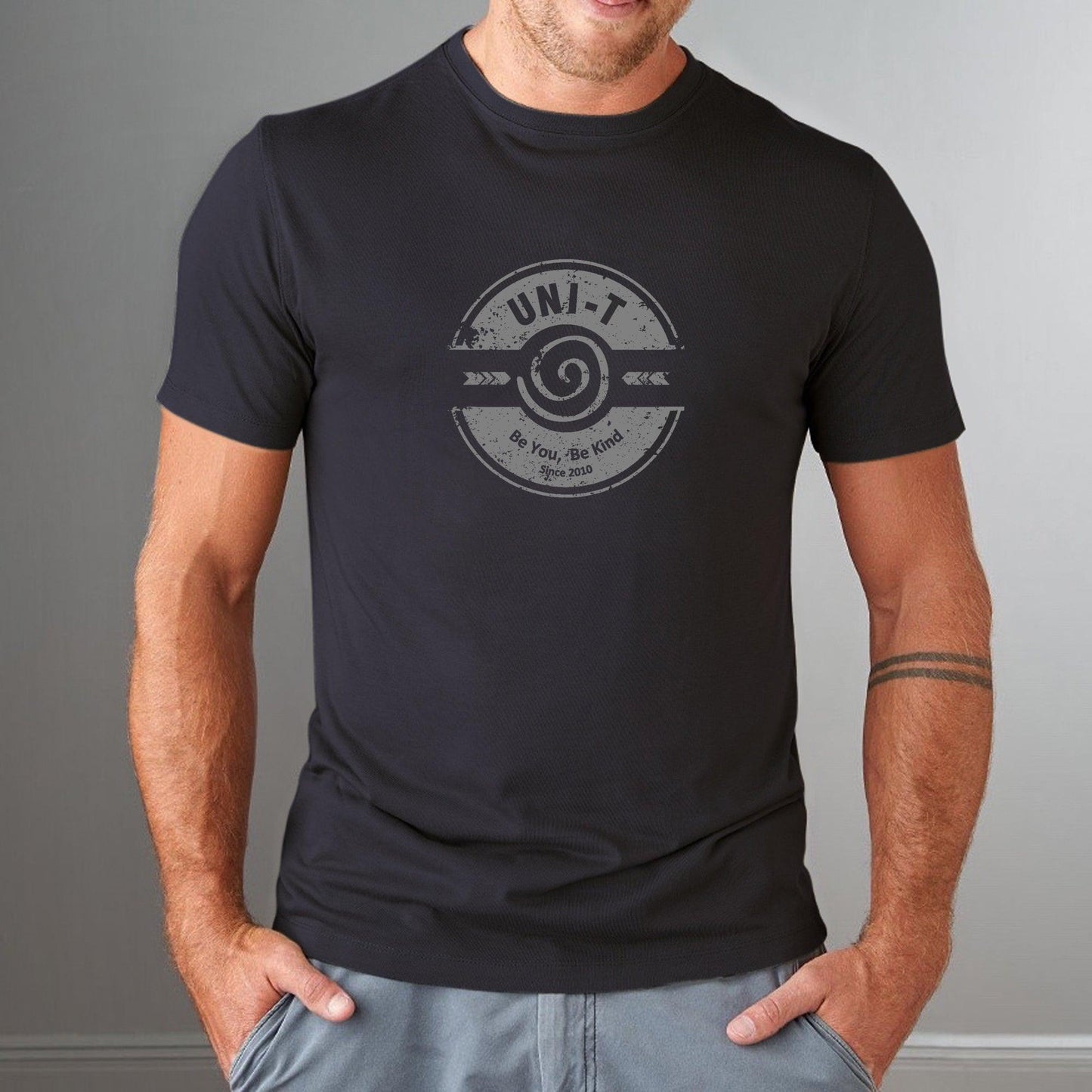 Black fitted men's bamboo & organic cotton t-shirt with subtle 'Be You Be Kind' graphic by Uni-T, soft eco-conscious inspirational wear.