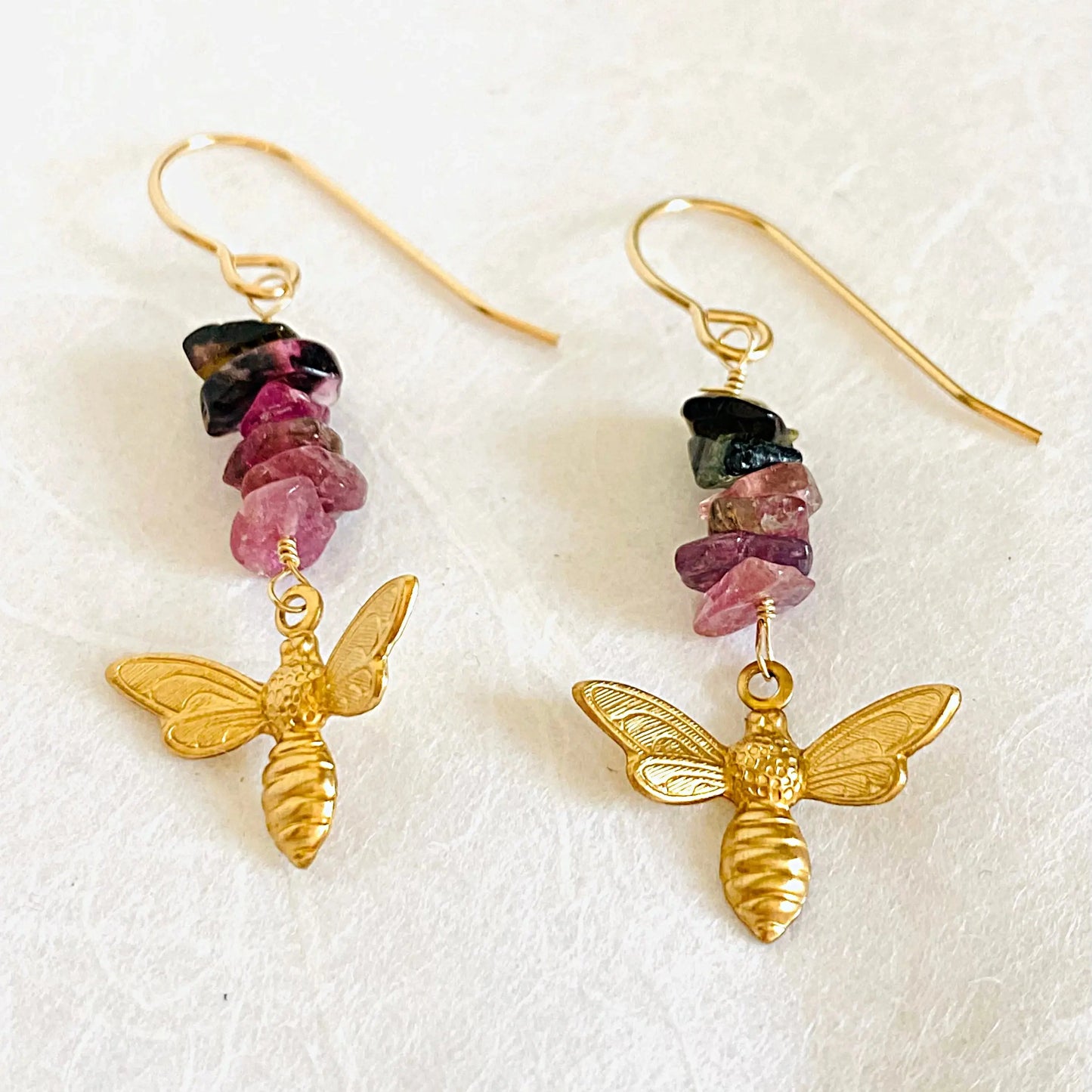 Tourmaline Gemstone Earrings with dangling golden bee charms and multicolored stone chips. Stylish brass earrings for nature jewelry collections.