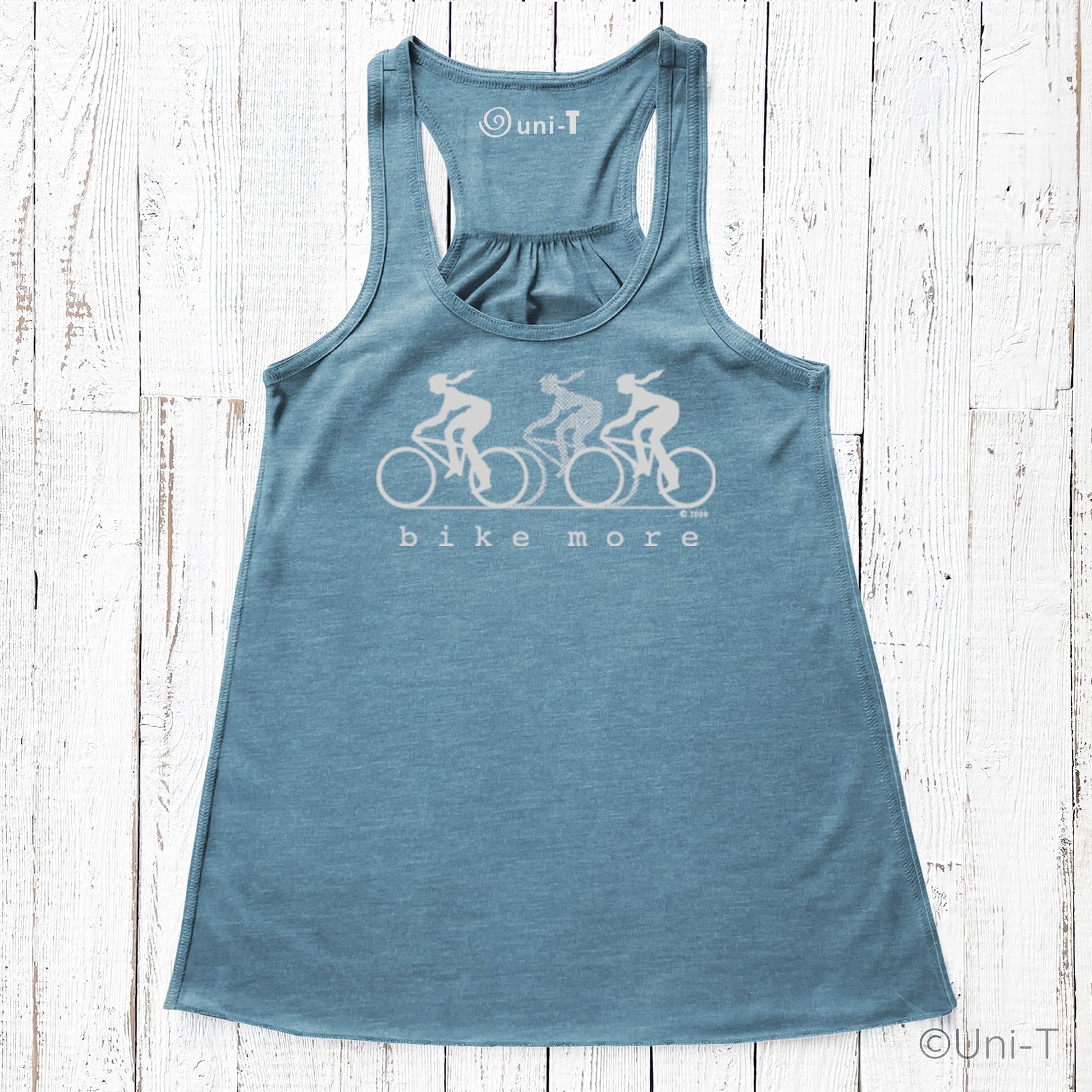 Teal blue racerback flowy tank top for women featuring eco-friendly 'bike more' cycling design, perfect for casual or athletic wear.
