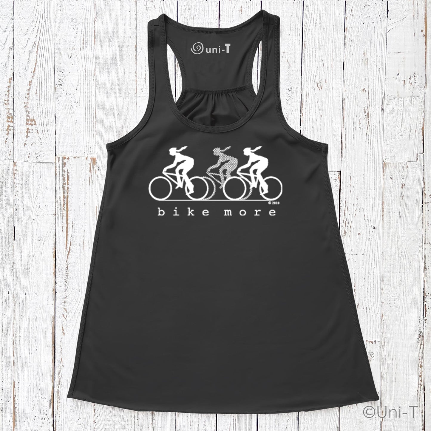 Black racerback flowy tank top for women with white 'bike more' cycling graphic, promoting sustainable living and active fashion.