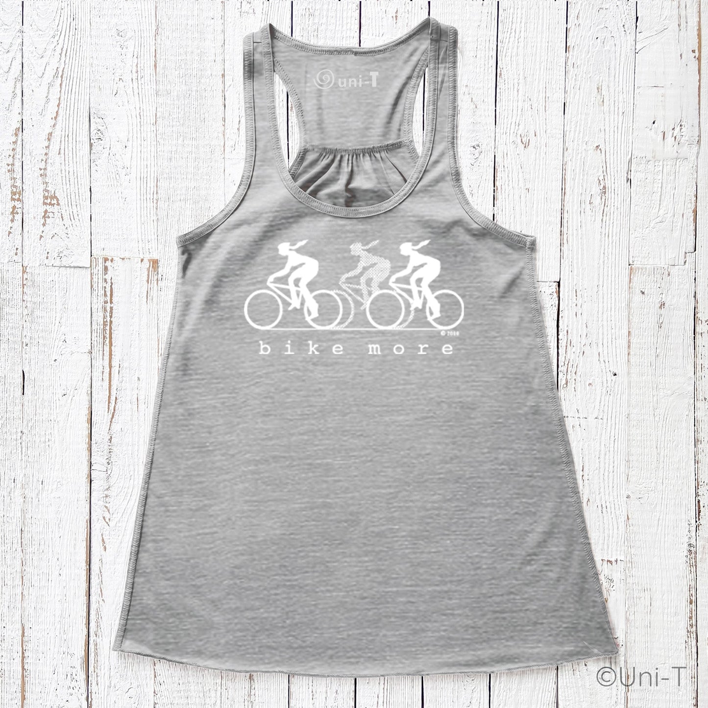 Heather gray flowy tank top for women with white 'bike more' cyclist print, combining comfort and eco-friendly style for cycling lovers.