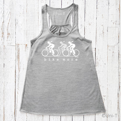 Heather gray flowy tank top for women with white 'bike more' cyclist print, combining comfort and eco-friendly style for cycling lovers.