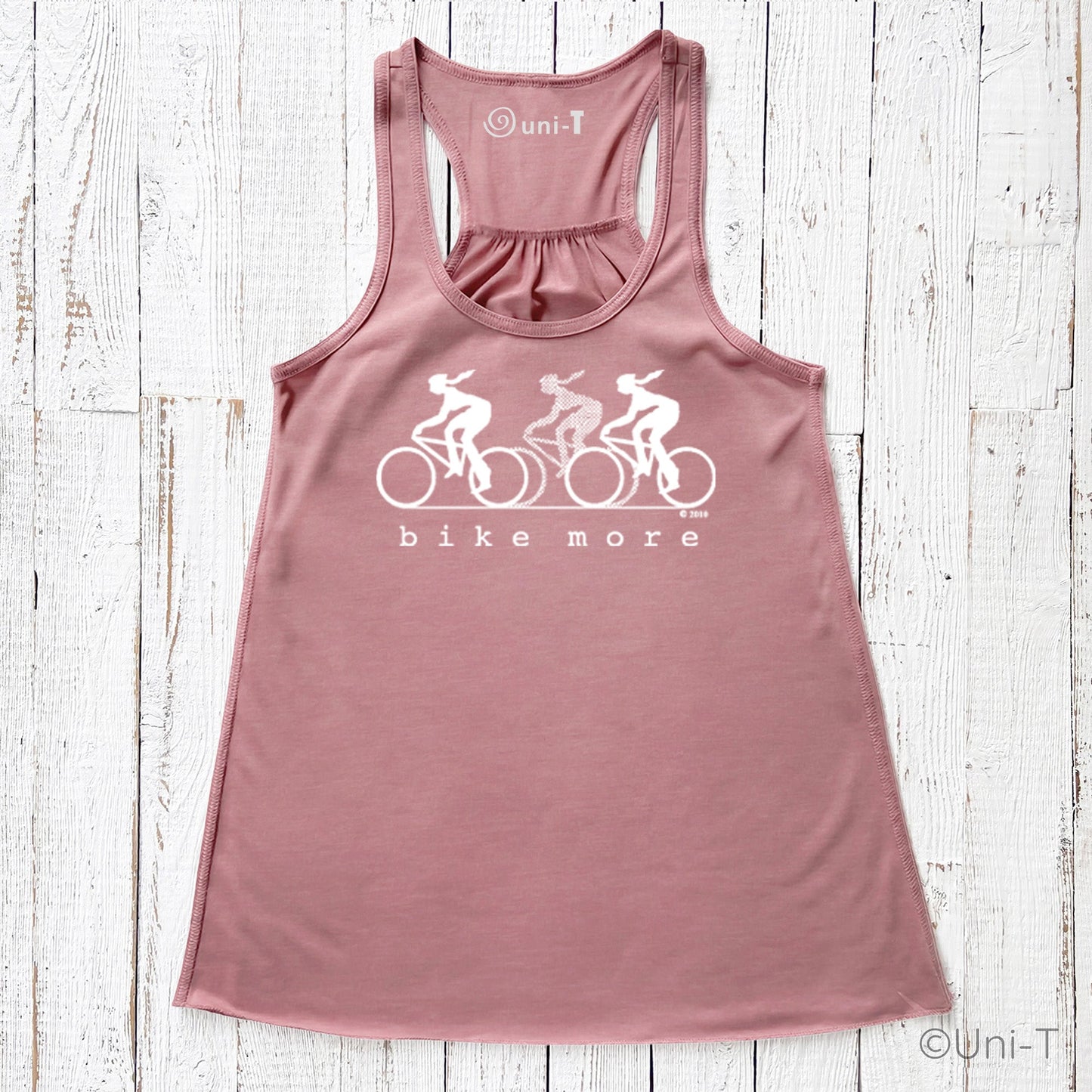 Dusty rose flowy tank top for women with white 'bike more' cycling design, ideal for promoting wellness and eco-transportation fashion.