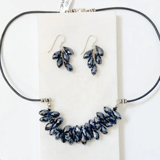 Black Crystal Jewelry Set featuring a 19” leather necklace and matching sterling silver earrings with faceted black crystals in hematite tones.