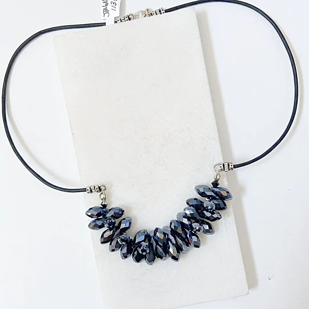 Full view of the Black Crystal Necklace with hematite-toned crystals on a black leather cord, part of the Black Crystal Jewelry Set.