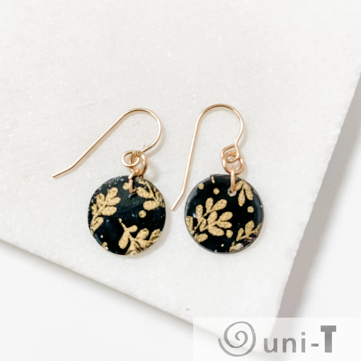 Black and Gold Earrings with stunning circle design and gold ear-wires, featuring gold leaf patterns on polymer clay, 1”x1.5” size.