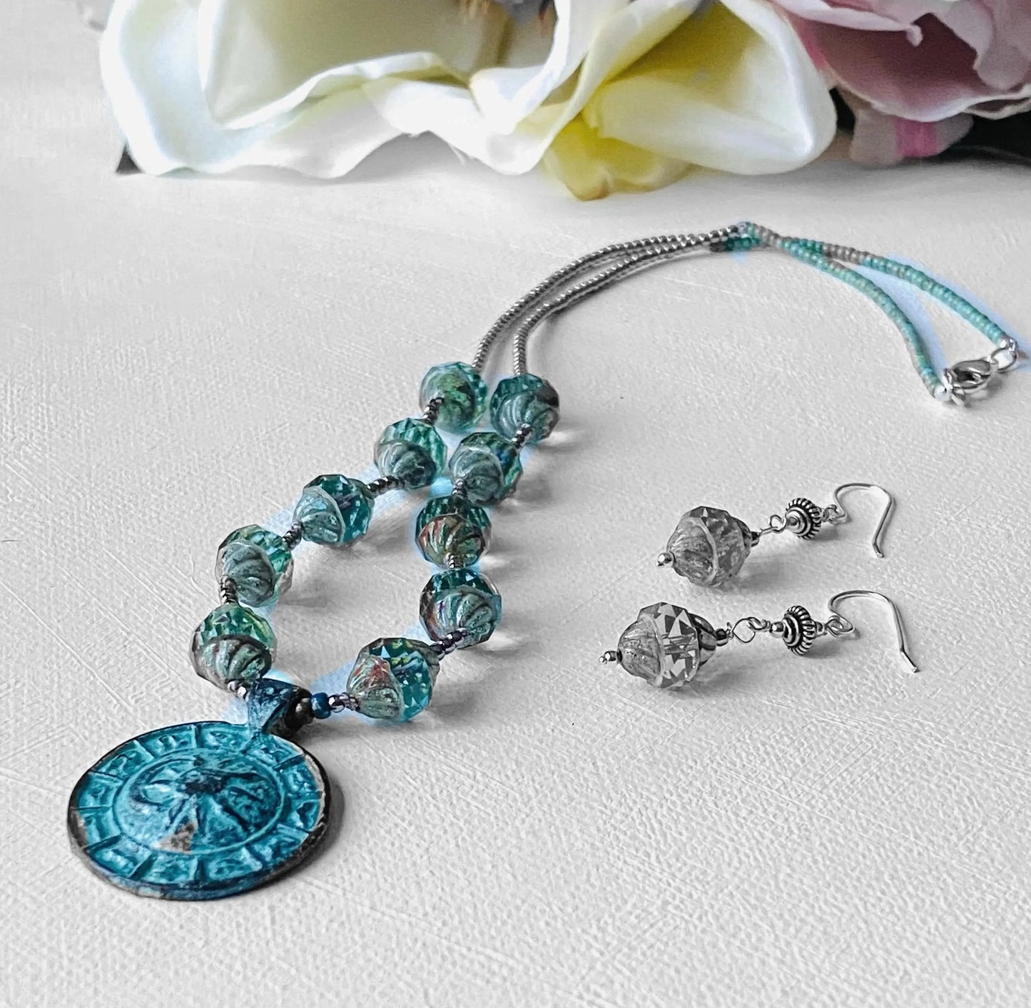 Celestial Necklace - Sun Moon Pendant Set with antique brass medallion, glass beads, and matching sterling silver earrings on white background.