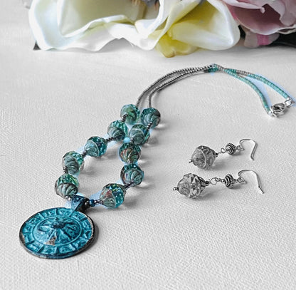 Celestial Necklace - Sun Moon Pendant Set with antique brass medallion, glass beads, and matching sterling silver earrings on white background.