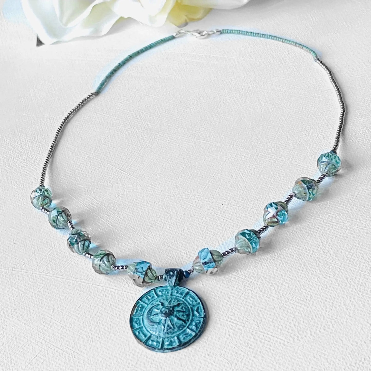 Celestial Necklace - Sun Moon Pendant Set featuring turquoise glass beads and a detailed antique-style sun moon medallion on an 18-inch chain.