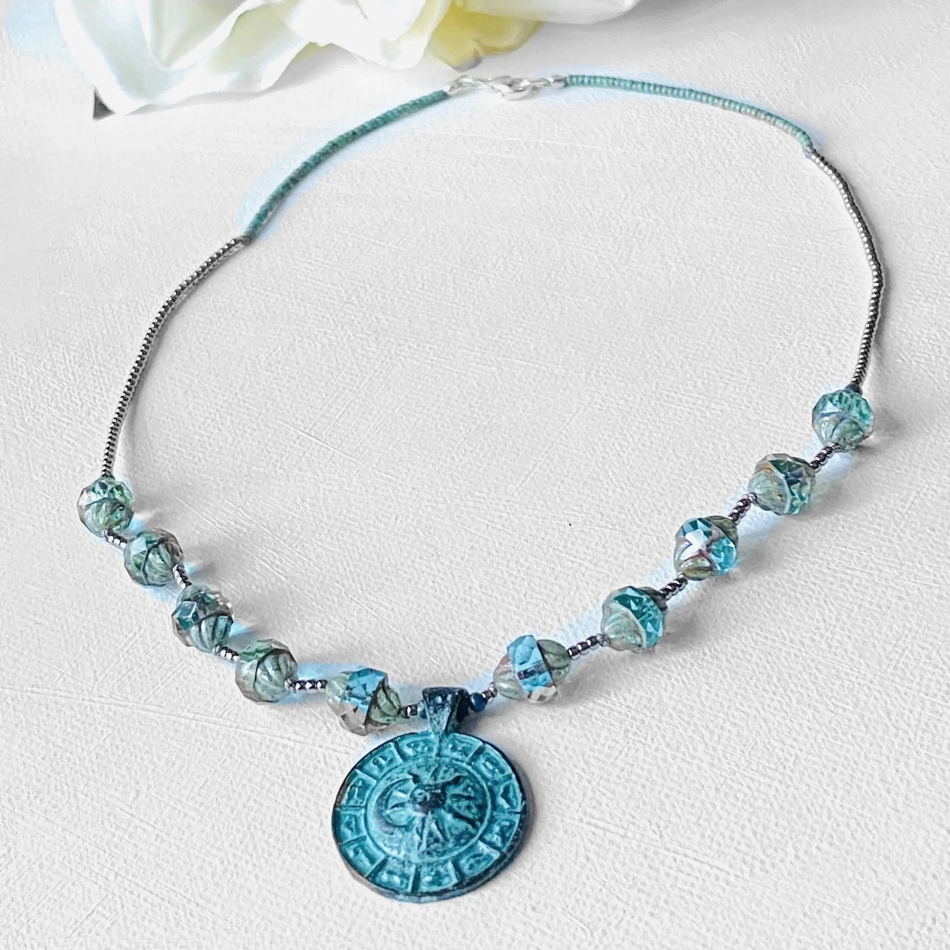 Celestial Necklace - Sun Moon Pendant Set featuring turquoise glass beads and a detailed antique-style sun moon medallion on an 18-inch chain.