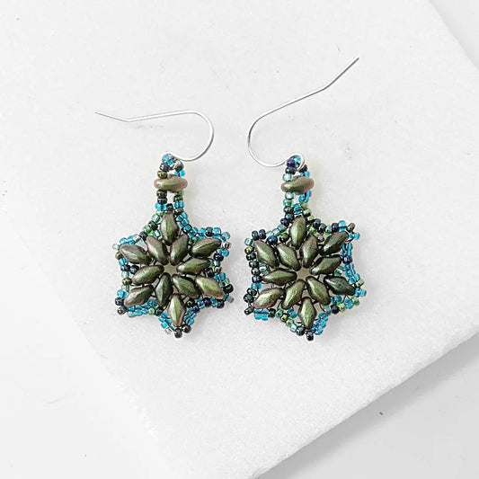 Sterling silver flower medallion earrings with frosted green petals and blue glass beads. Elegant floral jewelry for accessory lovers.