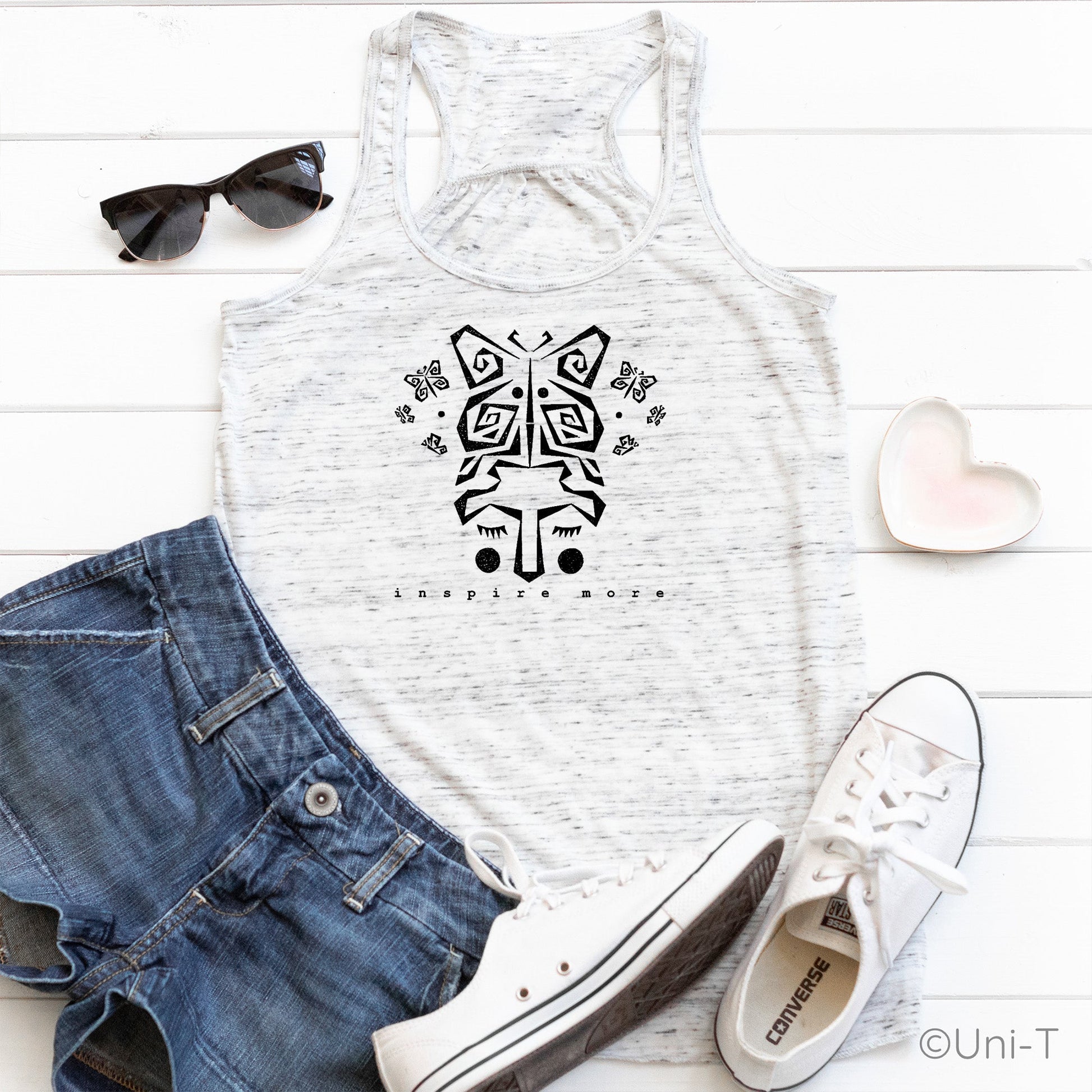 White "Inspire More" Butterfly Tank Top styled with denim shorts and sneakers. Soft, eco-conscious tank top for women embracing transformation.