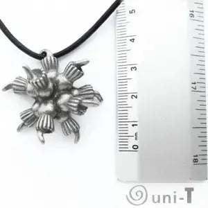 Choanoflagellate Colony Pendant next to ruler for scale, highlighting the pendant's compact size and detailed craftsmanship.