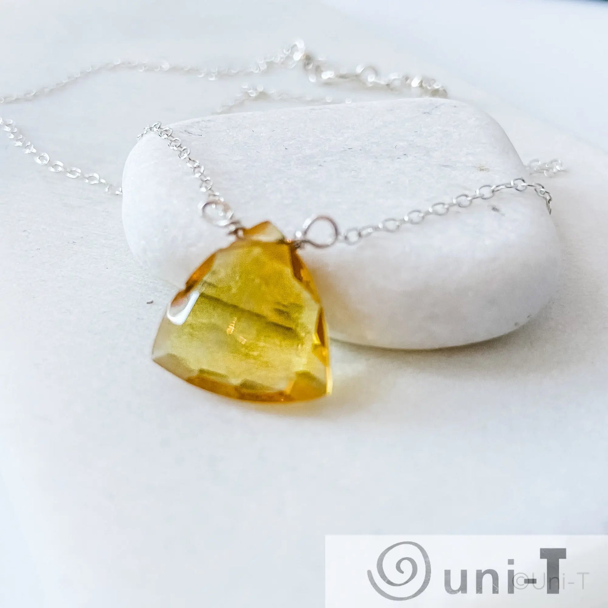 Close-up of Citrine Gemstone Necklace showing faceted yellow gemstone pendant on delicate sterling silver chain, handcrafted by Uni-T.