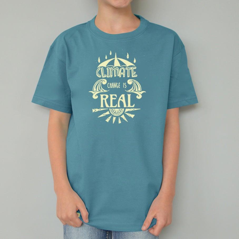 Child wearing teal Kids' Organic Cotton T-Shirt with yellow 'Climate Change Is Real' print. Eco-friendly activist apparel by Uni-T.