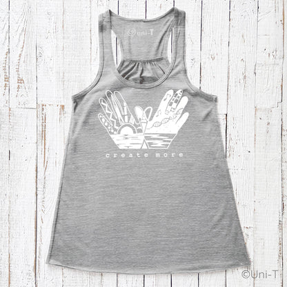 Gray 'Create More' flowy tank top for women featuring artistic hand graphic and sunrise design. Creative apparel for artists and makers.