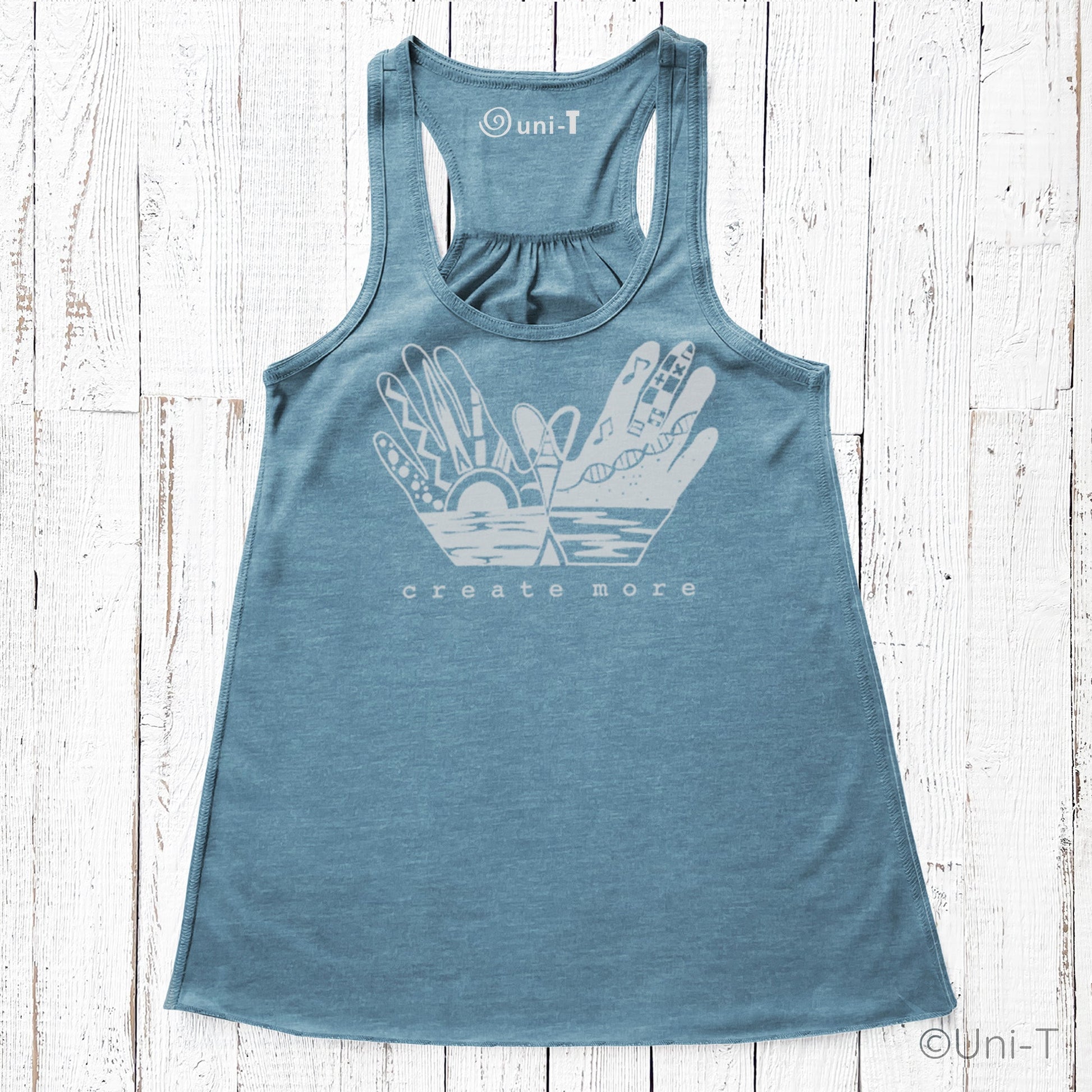 Blue 'Create More' women's flowy tank top with white artistic hand and sun print. Eco-friendly and perfect for creative expression.