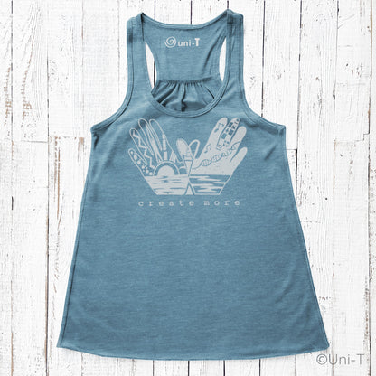 Blue 'Create More' women's flowy tank top with white artistic hand and sun print. Eco-friendly and perfect for creative expression.