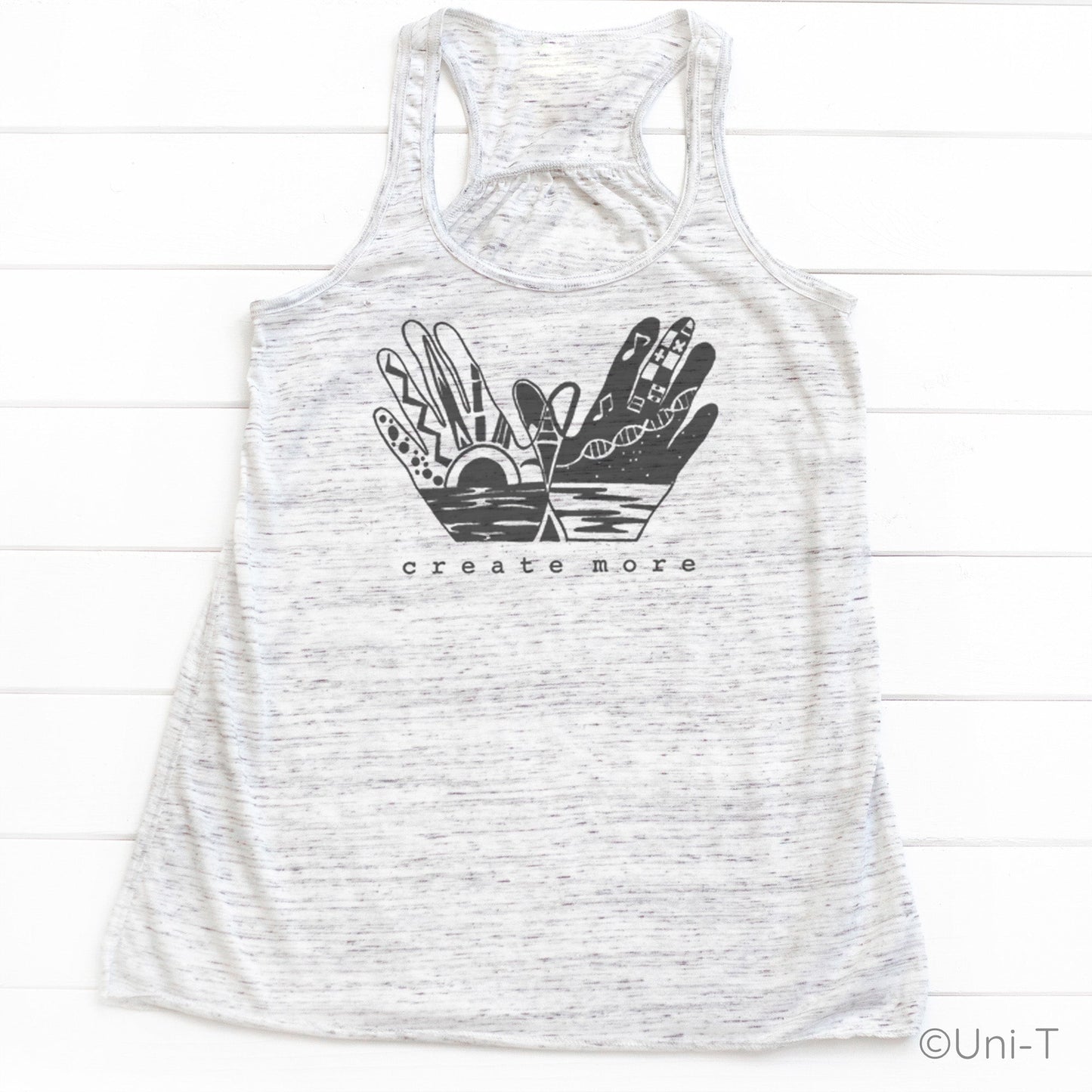 Heather white 'Create More' tank top featuring black hand art and sunrise design. Lightweight and stylish tank for creative women.