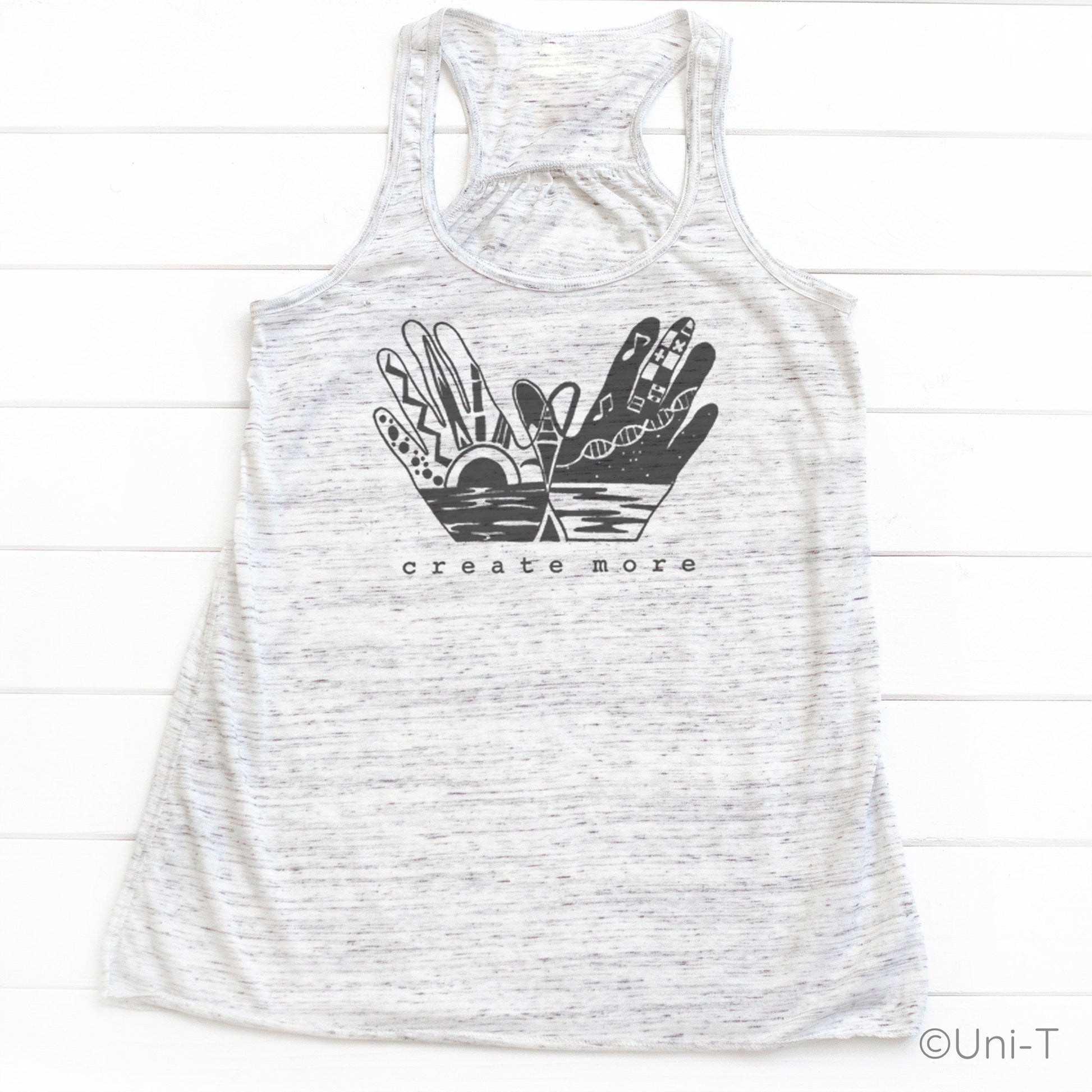 Heather white 'Create More' tank top featuring black hand art and sunrise design. Lightweight and stylish tank for creative women.