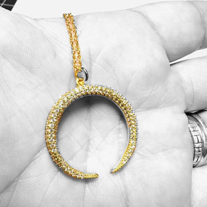 Gold crescent moon necklace with cubic zirconia shown in hand for scale, featuring an 18” rope chain and fine detailing for gifting or daily wear.