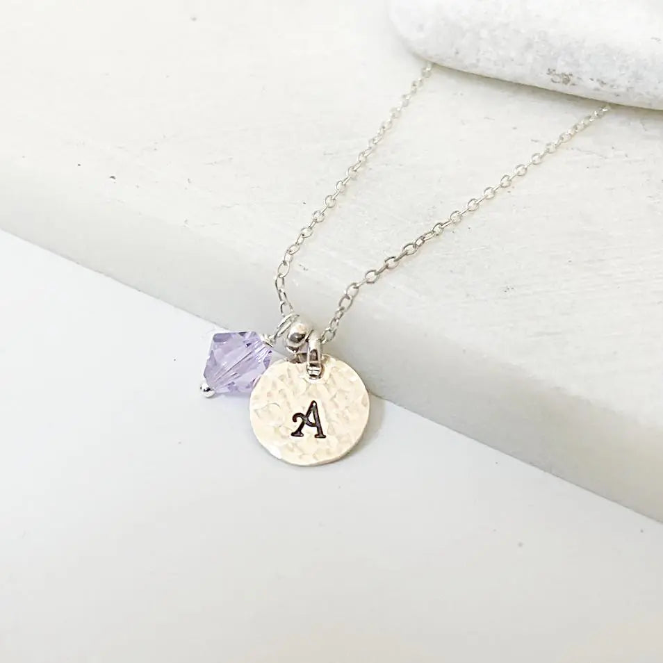 Custom Initial Necklace with silver chain, purple crystal charm, and hand-stamped 'A' pendant. Personalized jewelry gift option.
