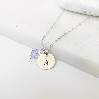 Custom Initial Necklace with silver chain, purple crystal charm, and hand-stamped 'A' pendant. Personalized jewelry gift option.