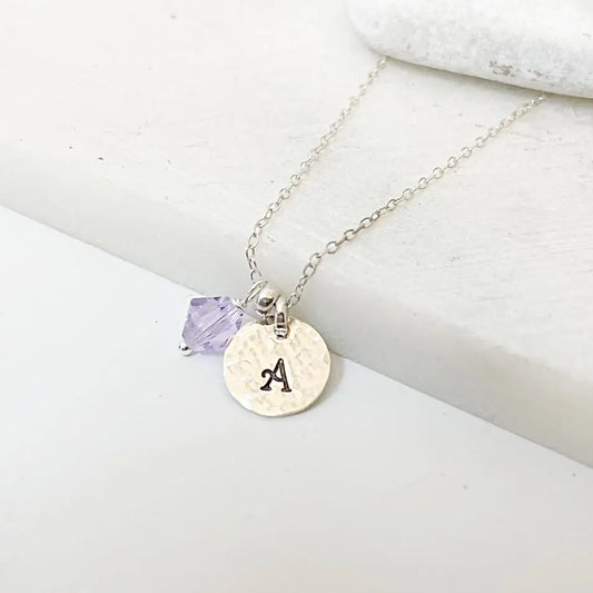 Custom Initial Necklace with silver chain, purple crystal charm, and hand-stamped 'A' pendant. Personalized jewelry gift option.