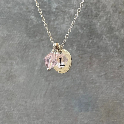 Personalized Initial Necklace featuring silver chain, pink crystal charm, and hammered disc with letter 'L'. Ideal custom gift accessory.