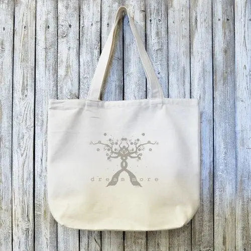 Dream Chaser Tote Bag - Organic Canvas Gift with 'dream more' tree design, ideal for carrying essentials in eco-friendly style.