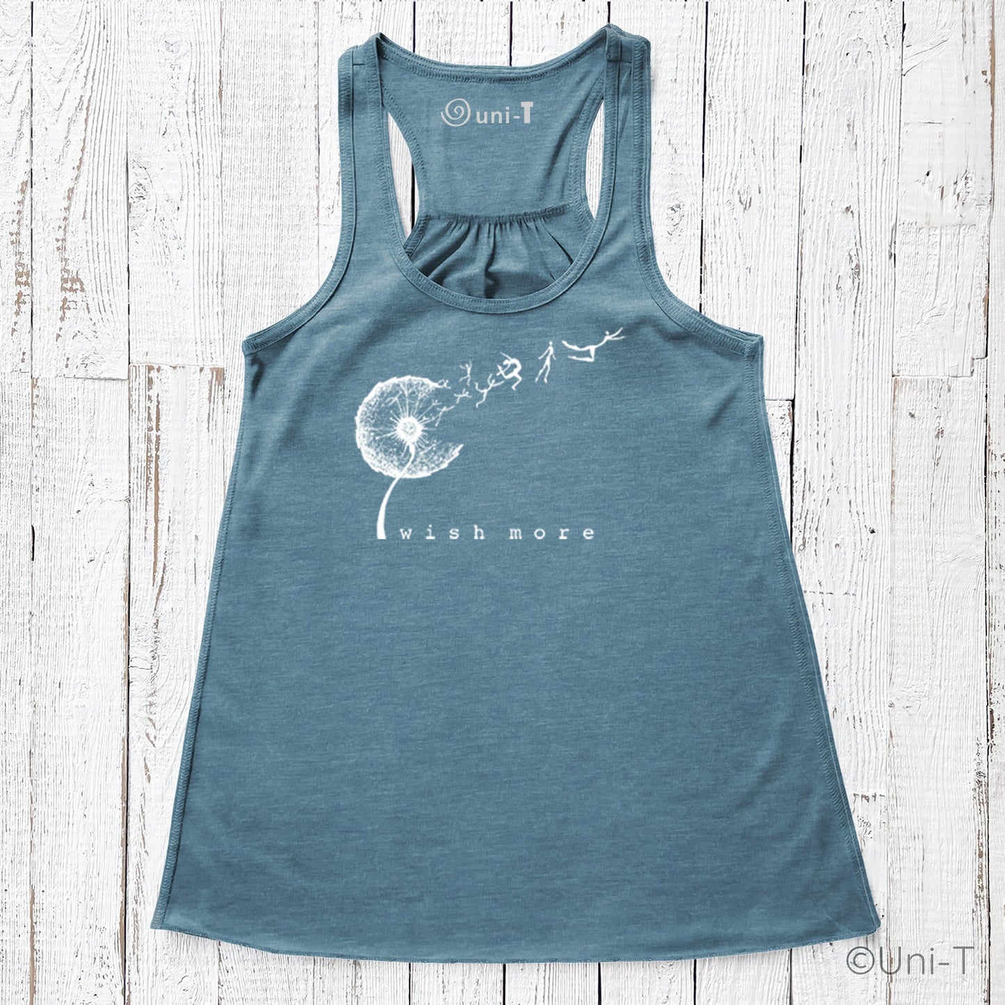 Wish More Flowy Tank in teal blue with white dandelion and flying figures design. Eco-friendly racerback top for women, soft and breathable.