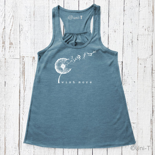 Wish More Flowy Tank in teal blue with white dandelion and flying figures design. Eco-friendly racerback top for women, soft and breathable.
