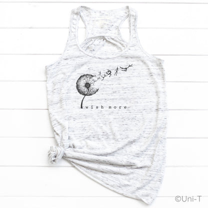 White marbled Wish More Flowy Tank Top tied at the hem, featuring a black dandelion and whimsical design. Lightweight and nature-inspired.