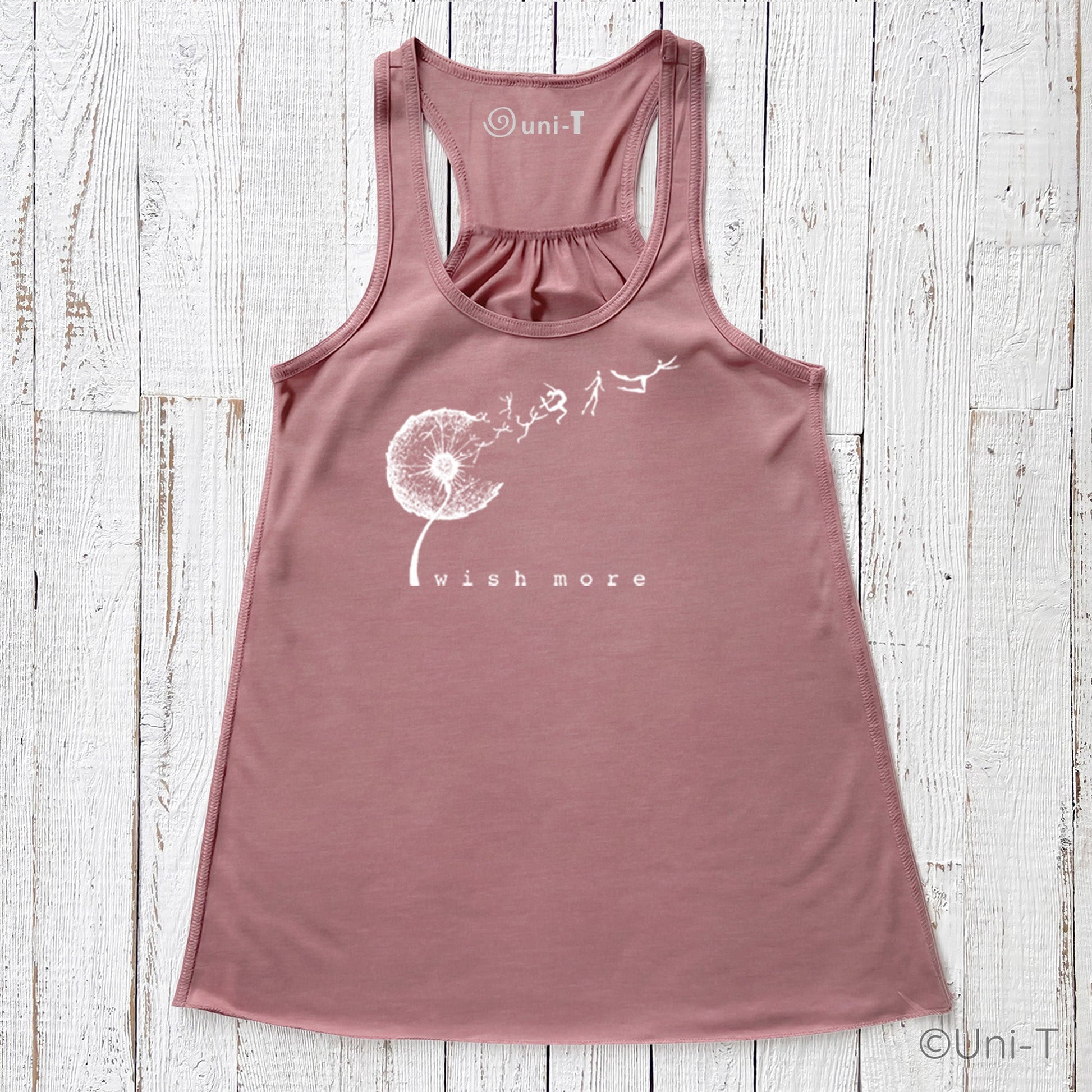 Dusty rose Wish More Flowy Tank Top with white dandelion and whimsical figures. Feminine racerback cut in soft, eco-friendly fabric.