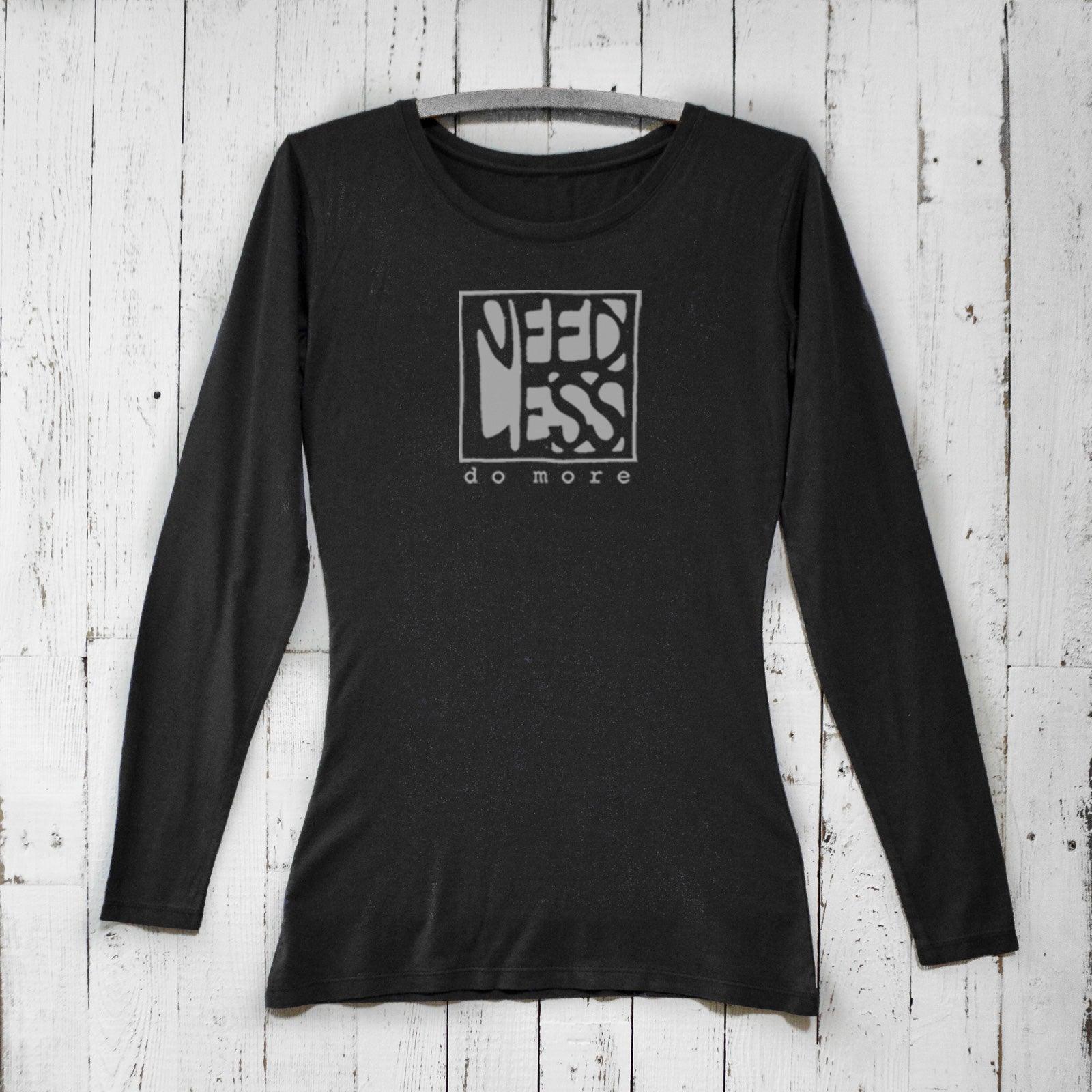 Black women's bamboo and organic cotton long sleeve T-shirt featuring 'Need Less Do More' graphic. Sustainable minimalist gift by Uni-T.