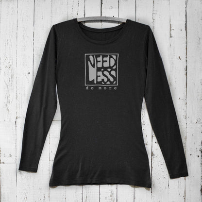 Black women's bamboo and organic cotton long sleeve T-shirt featuring 'Need Less Do More' graphic. Sustainable minimalist gift by Uni-T.
