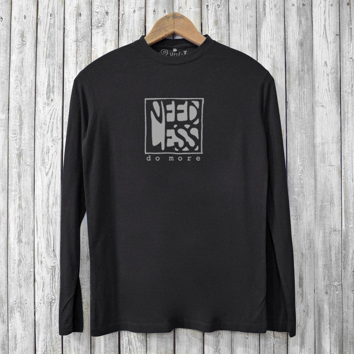 Black men's bamboo long sleeve t-shirt featuring 'Need Less Do More' print. Made from organic cotton blend for breathable comfort.