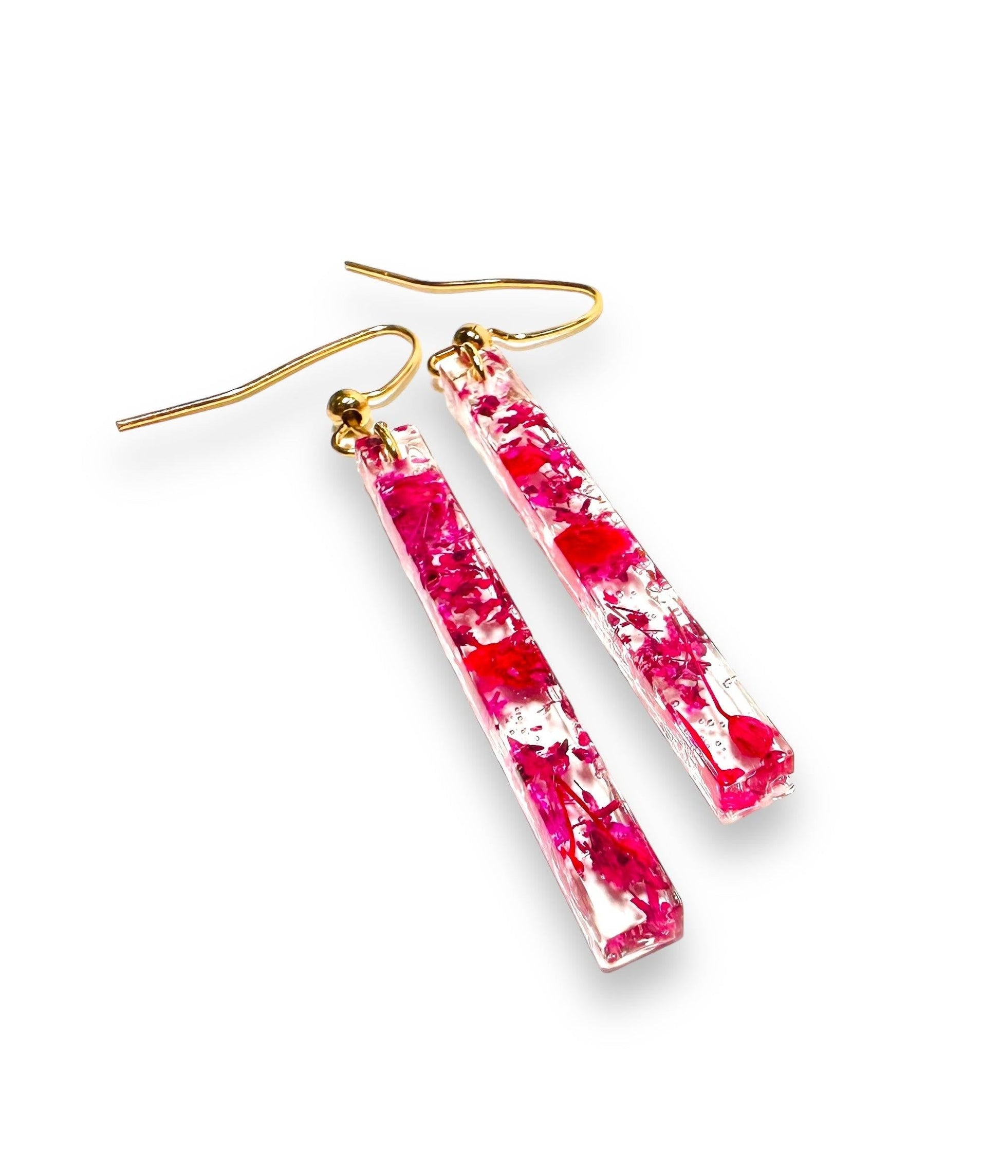 Long rectangular resin earrings with pink and white flowers. Gold hooks highlight the floral design in the Real Flower Earrings series.