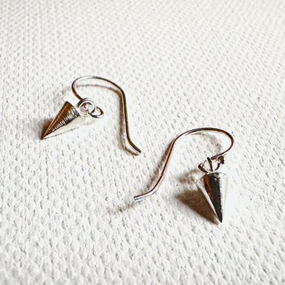 Detailed view of Tiny Spike Earrings-Uni-T - Sterling Silver with textured spike charms and curved hooks, perfect for silver jewelry lovers.