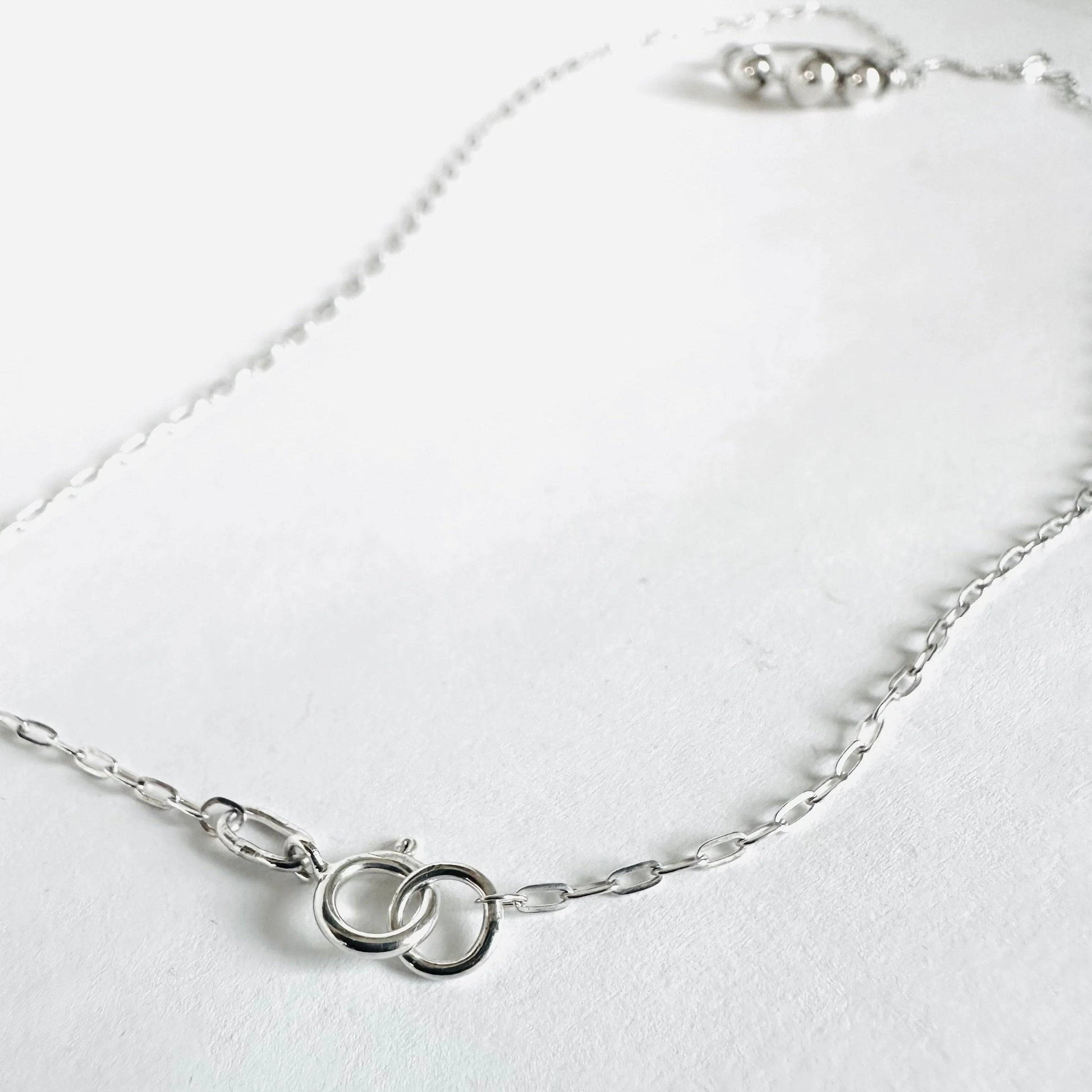 Back clasp view of Silver Circle Necklace showing interlocking rings on sterling chain. Elegant detail for a secure and stylish fit.