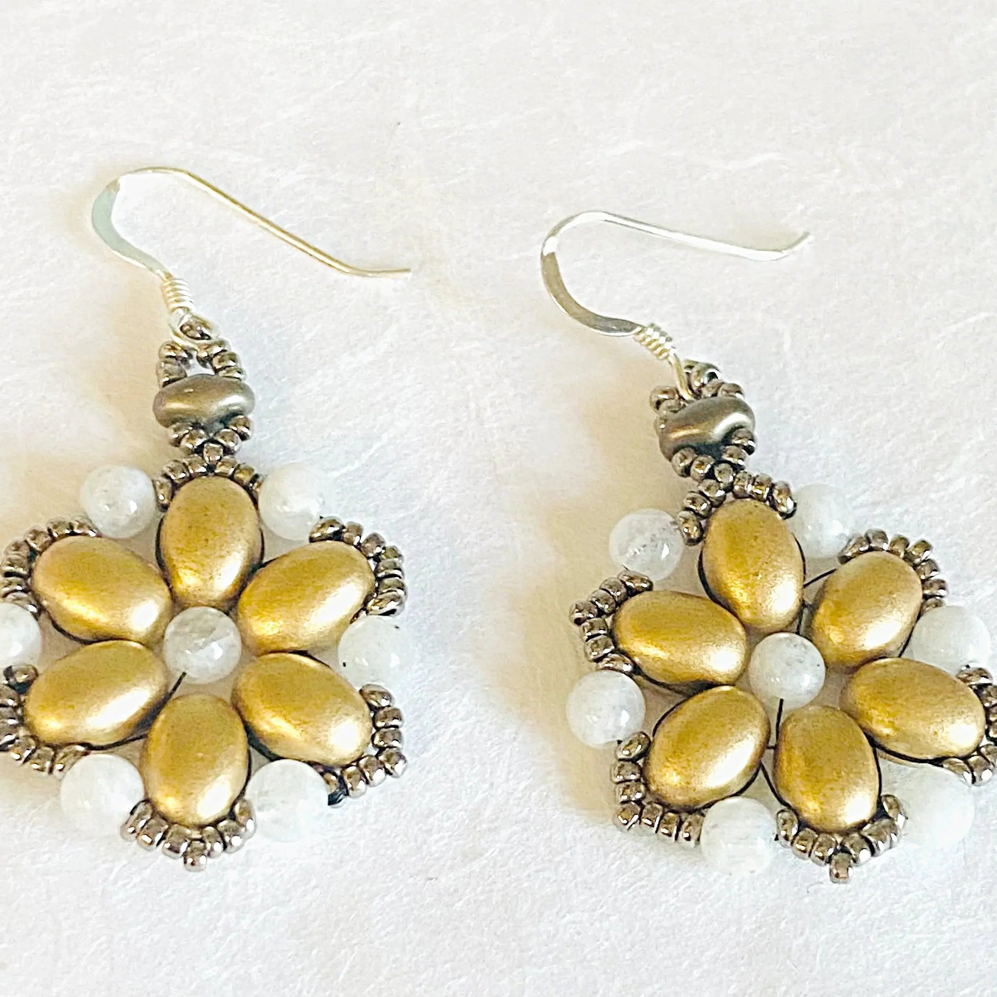 Flower-shaped Gold Medallion Earrings adorned with moonstone and glass beads. Stylish accessory for formal and casual wear.